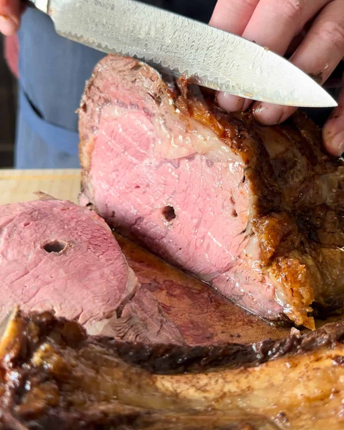Slice a bone in Rotisserie Prime Rib Roast