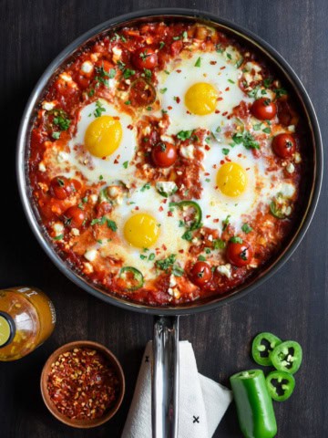 A skillet of spicy shakshuka - eggs in tomato sauce