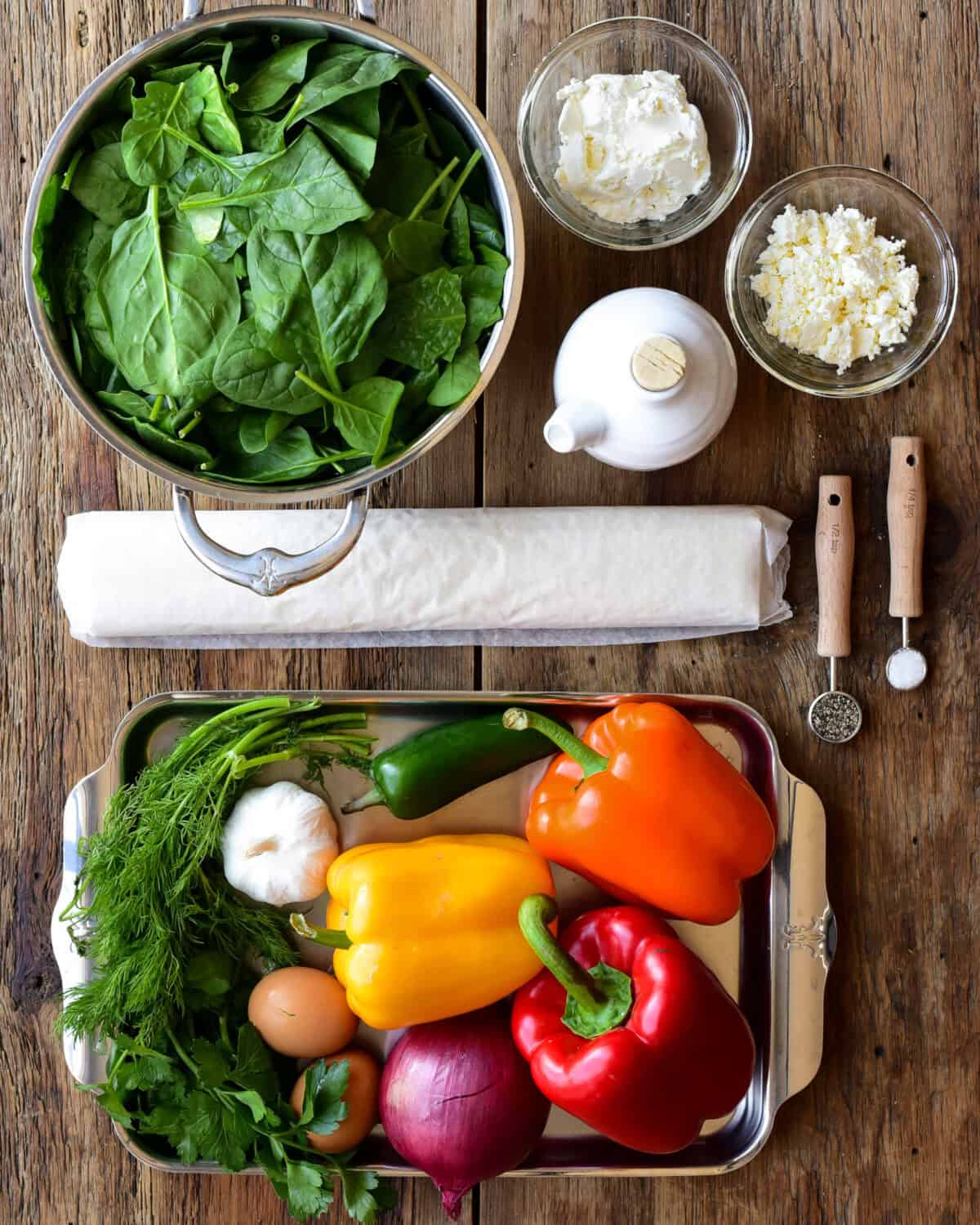 Ingredients laid out to make a Spanakopita Stuffed Peppers recipe.