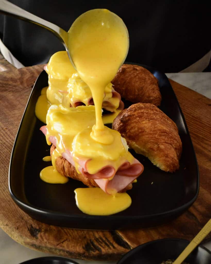 Spoon hollandaise sauce generously over the eggs.
