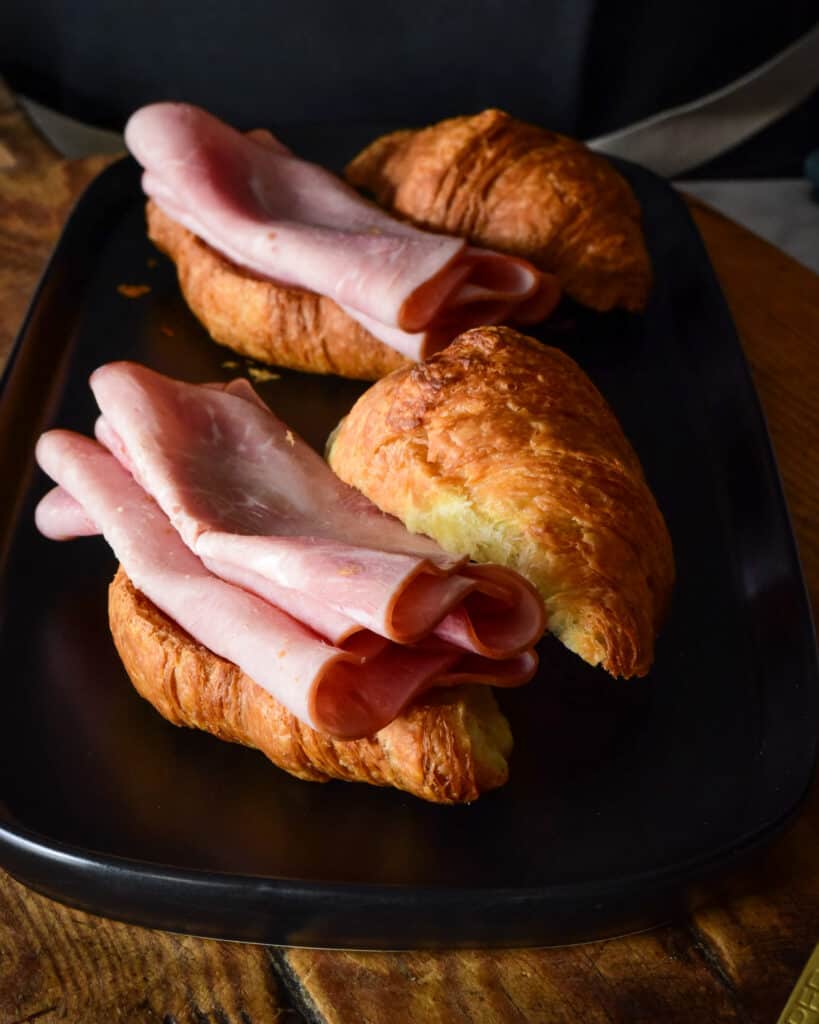 Place ham slices on the bottom croissant half.