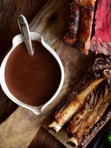 A bowl of homemade beef broth gravy served with prime rib.