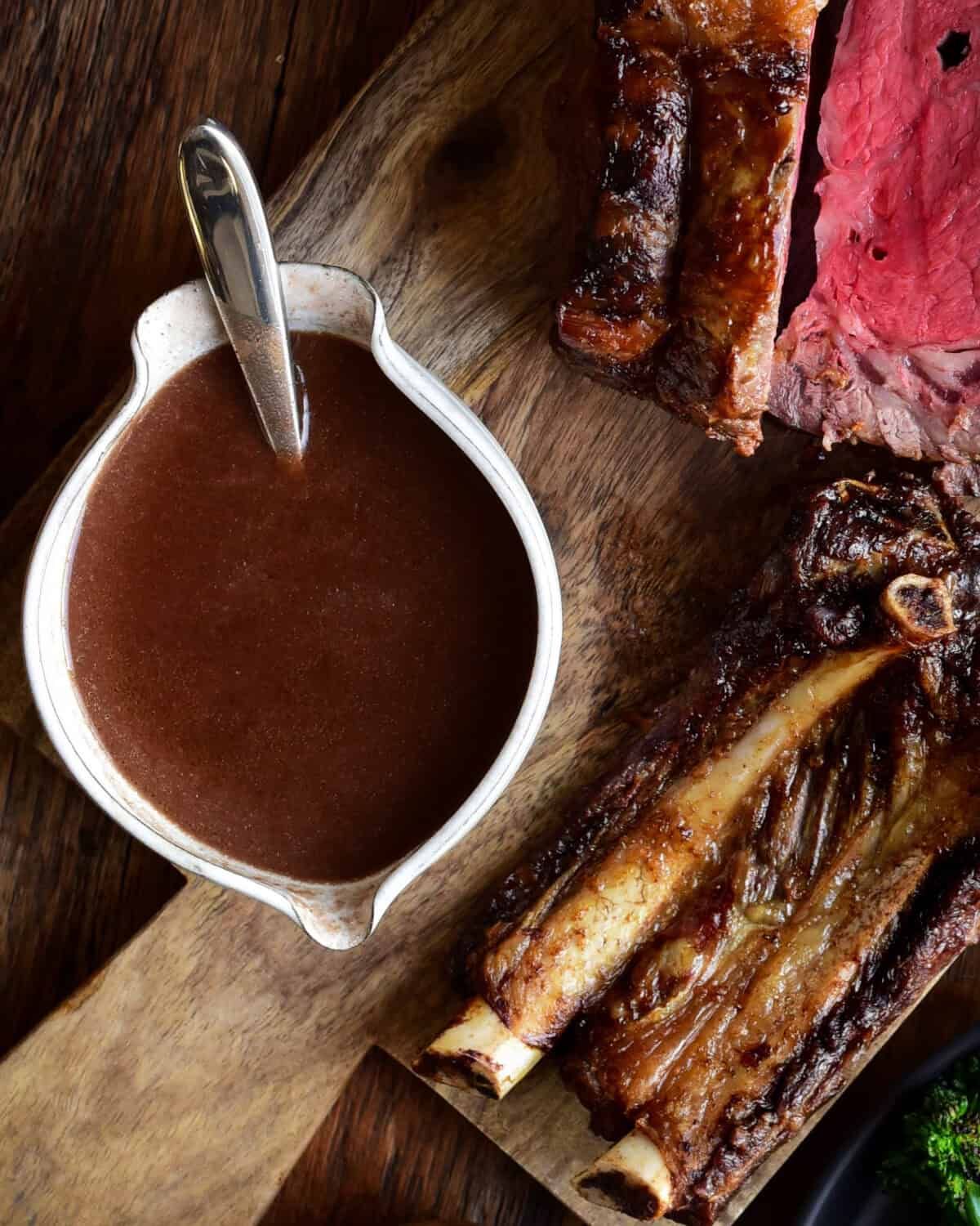 A bowl of homemade beef broth gravy served with prime rib.