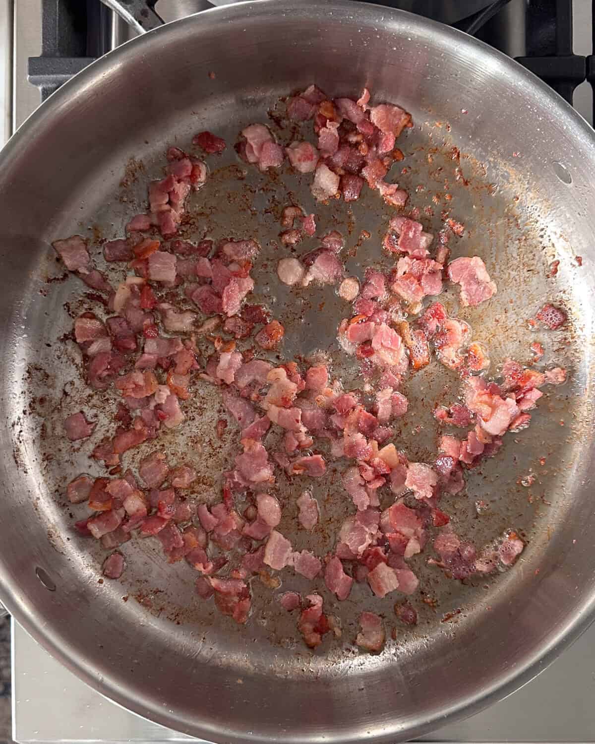 Add the diced bacon into a skillet and cook until crispy.