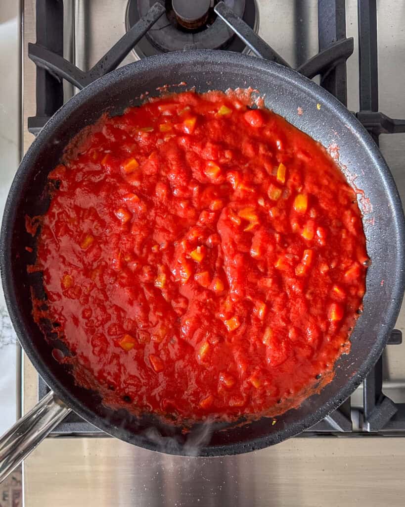 Using the same skillet from the sausage, make the tomato sauce.