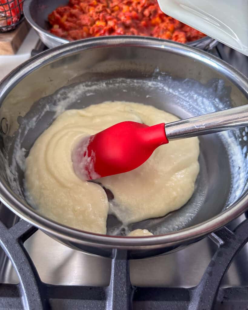 Add about ⅓ of the milk and stir until incorporated and a thicker paste has formed