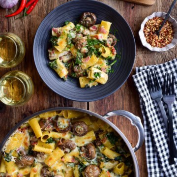 A bowl an pot filled with a Creamy Mushroom Pasta Bake.
