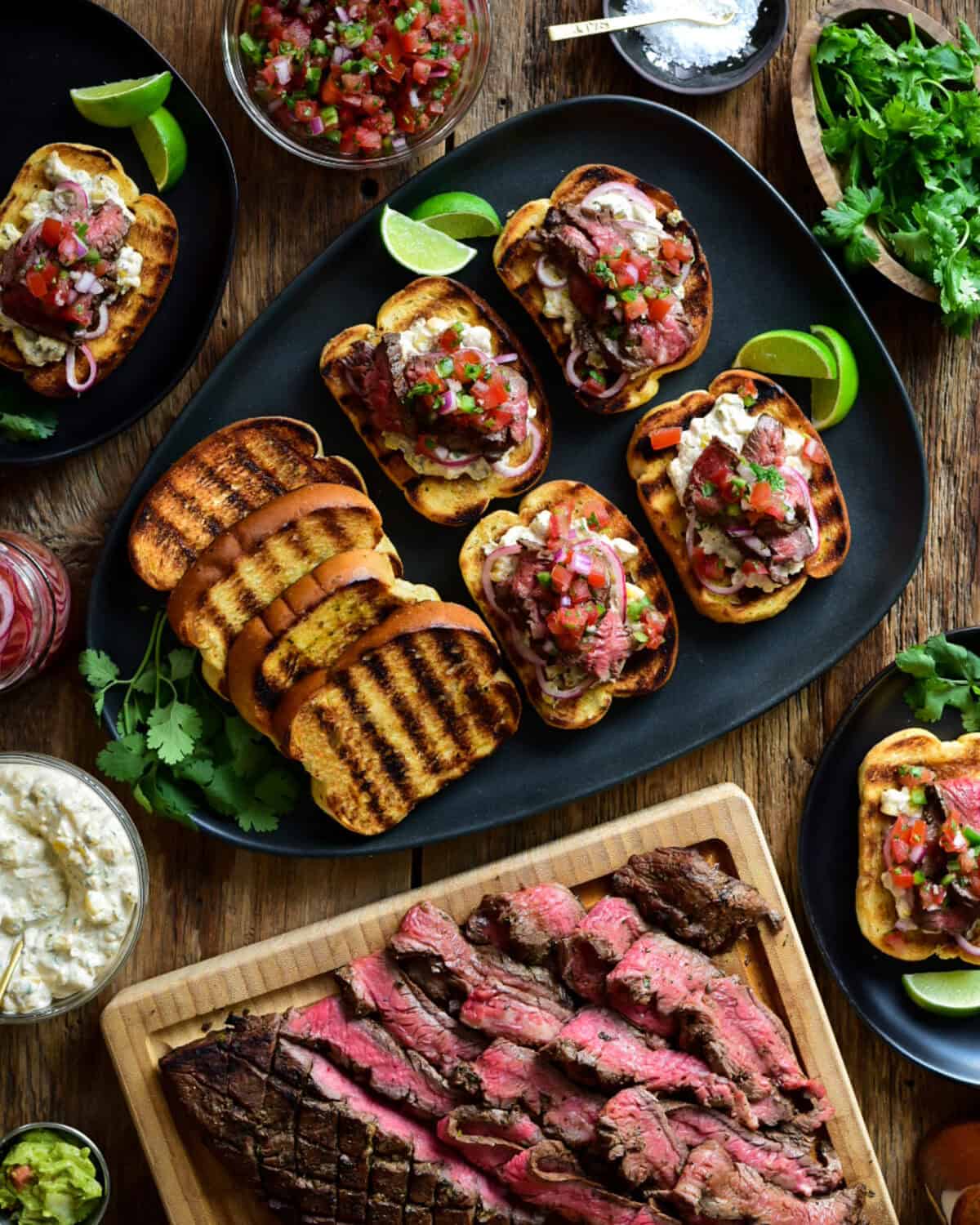 A platter of Flank Steak with Street Corn Mayo on Garlic Toasts.