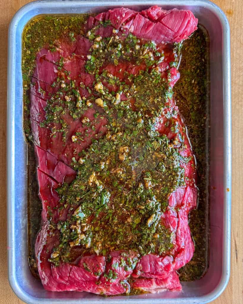 Place the flank steak into a large casserole dish or resealable bag, then pour over the marinade and turn several times to coat.