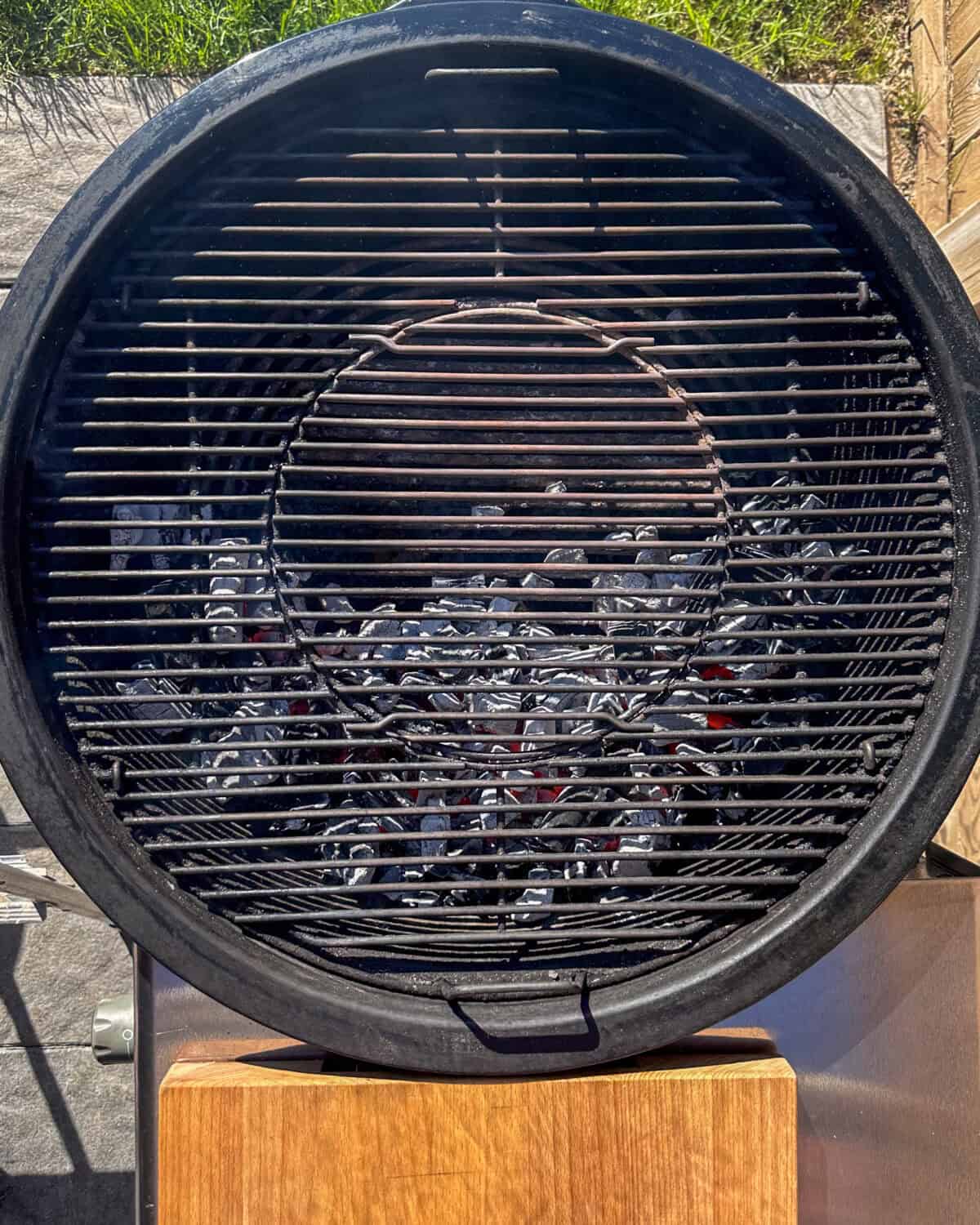 For charcoal grills, light the charcoal and let it burn until covered with white ash, then spread the coals evenly over half the grill.