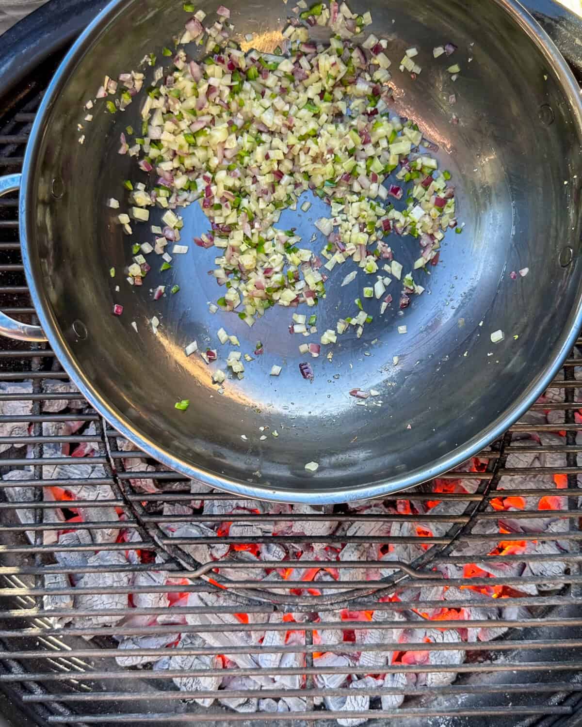 Cooking the aromatics in a wok over hot coals.