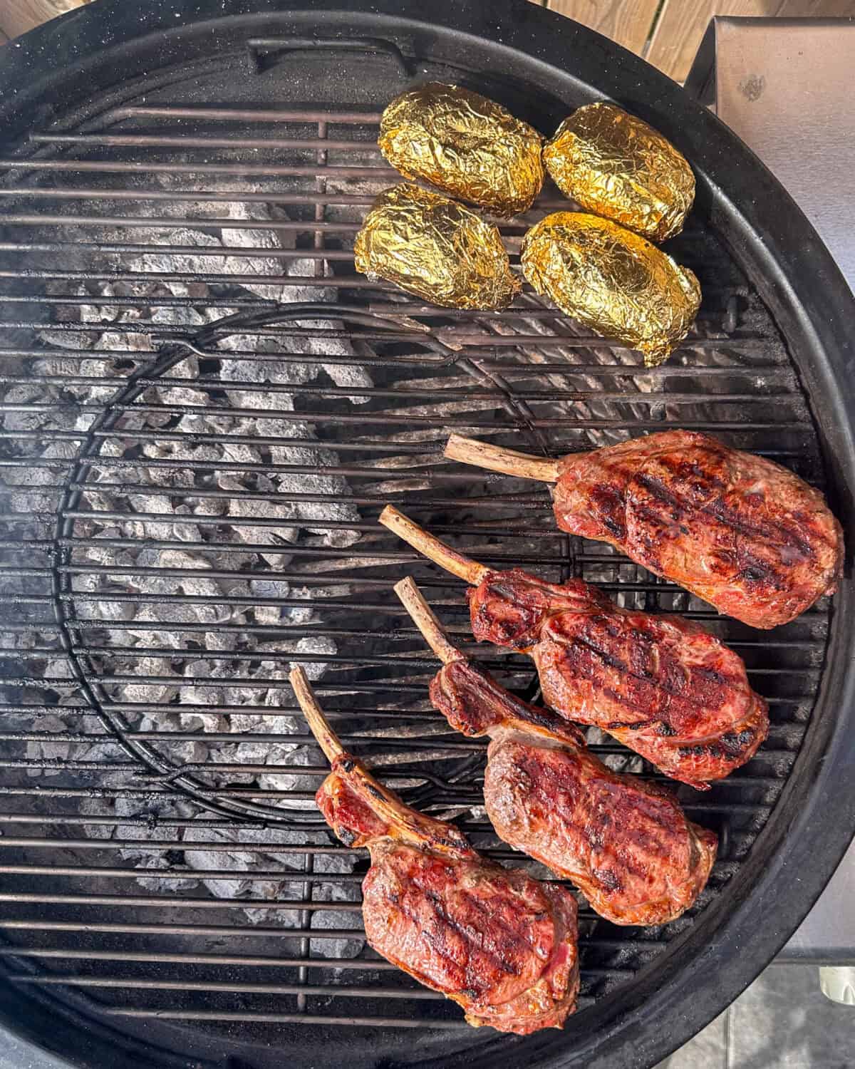 Four veal chops on bbq, finishing off on the indirect heat zone of the grill.