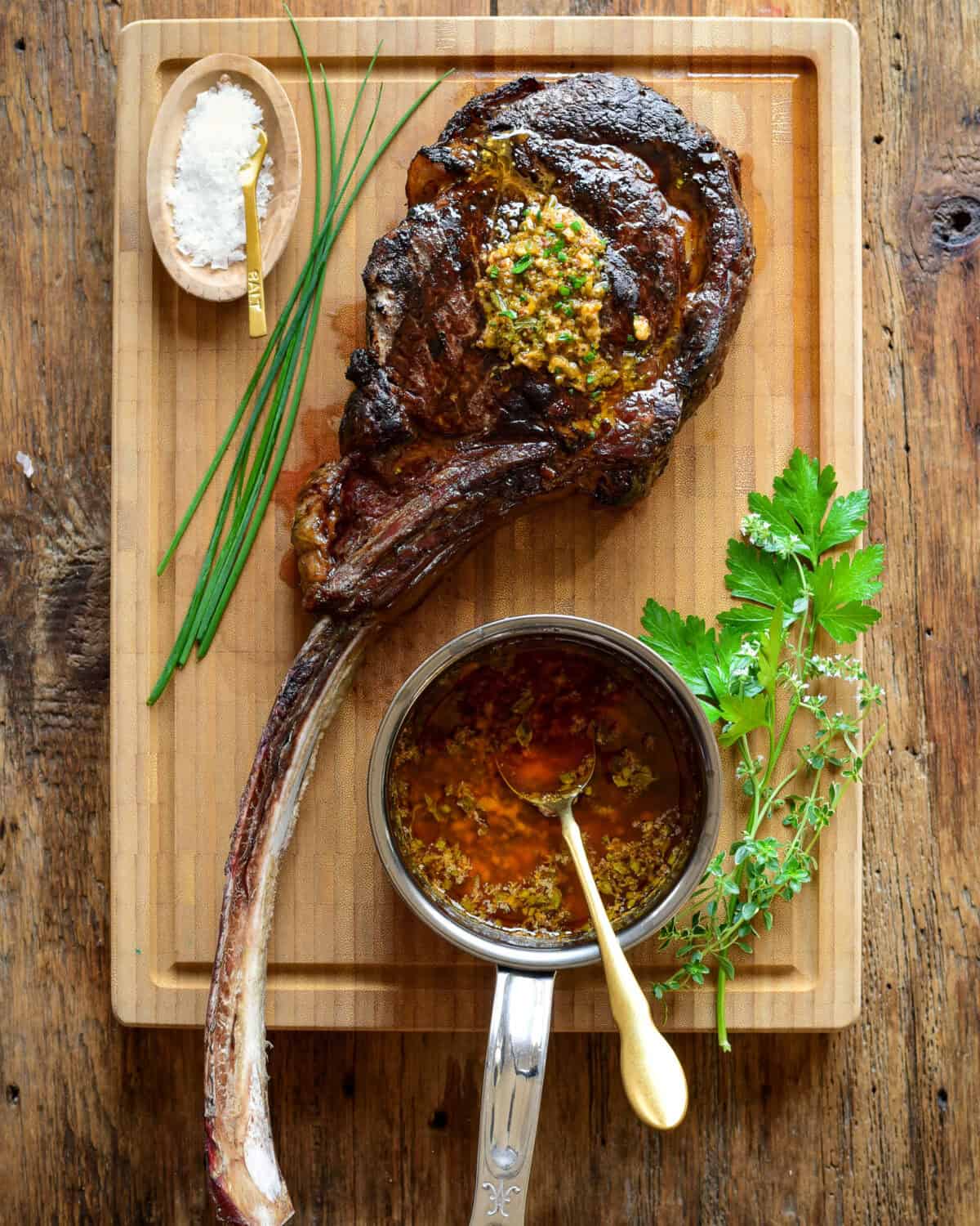 A perfectly grilled long bone ribeye with cowboy butter.