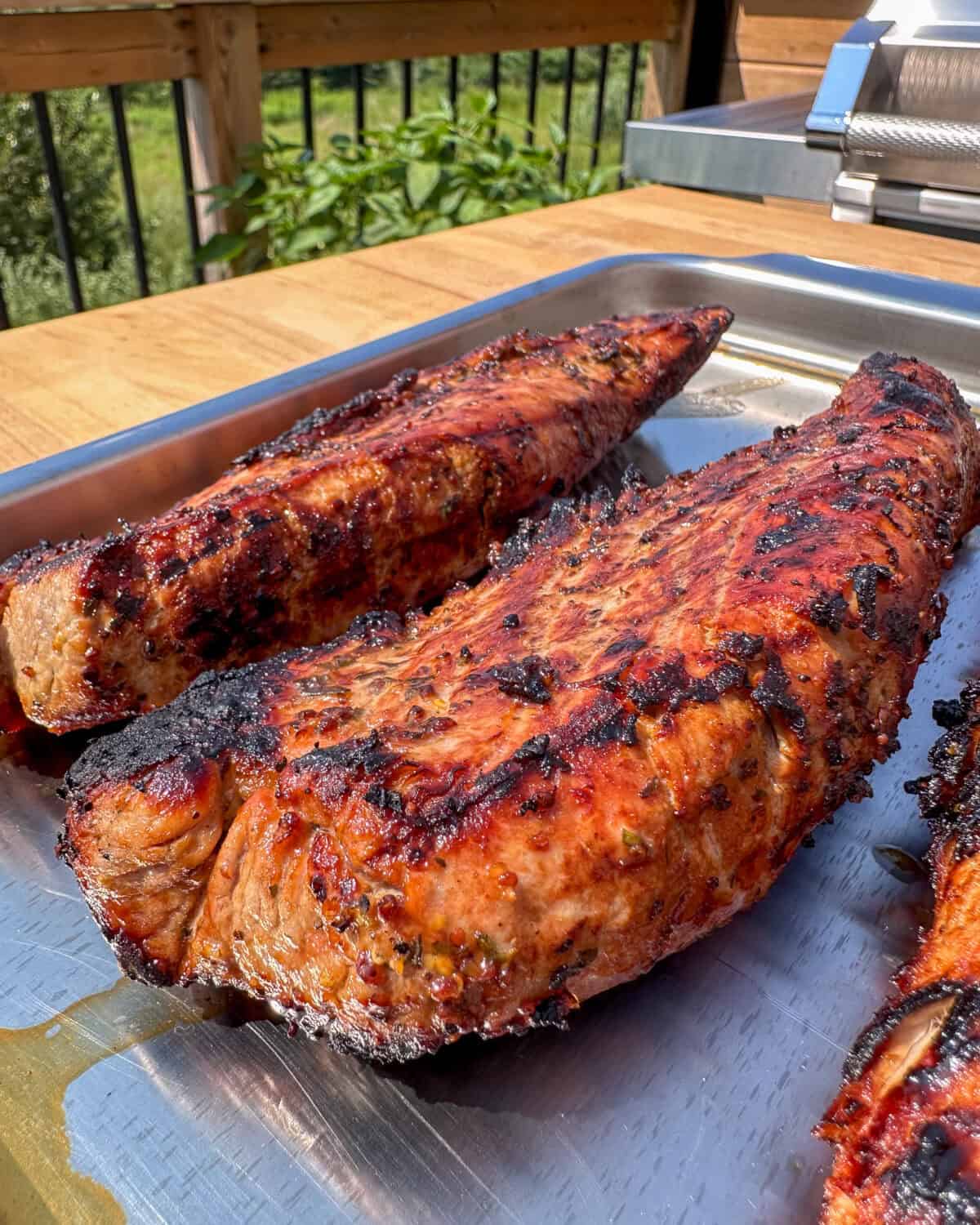 Resting tenderloins on a sheet pan for 3 minutes.