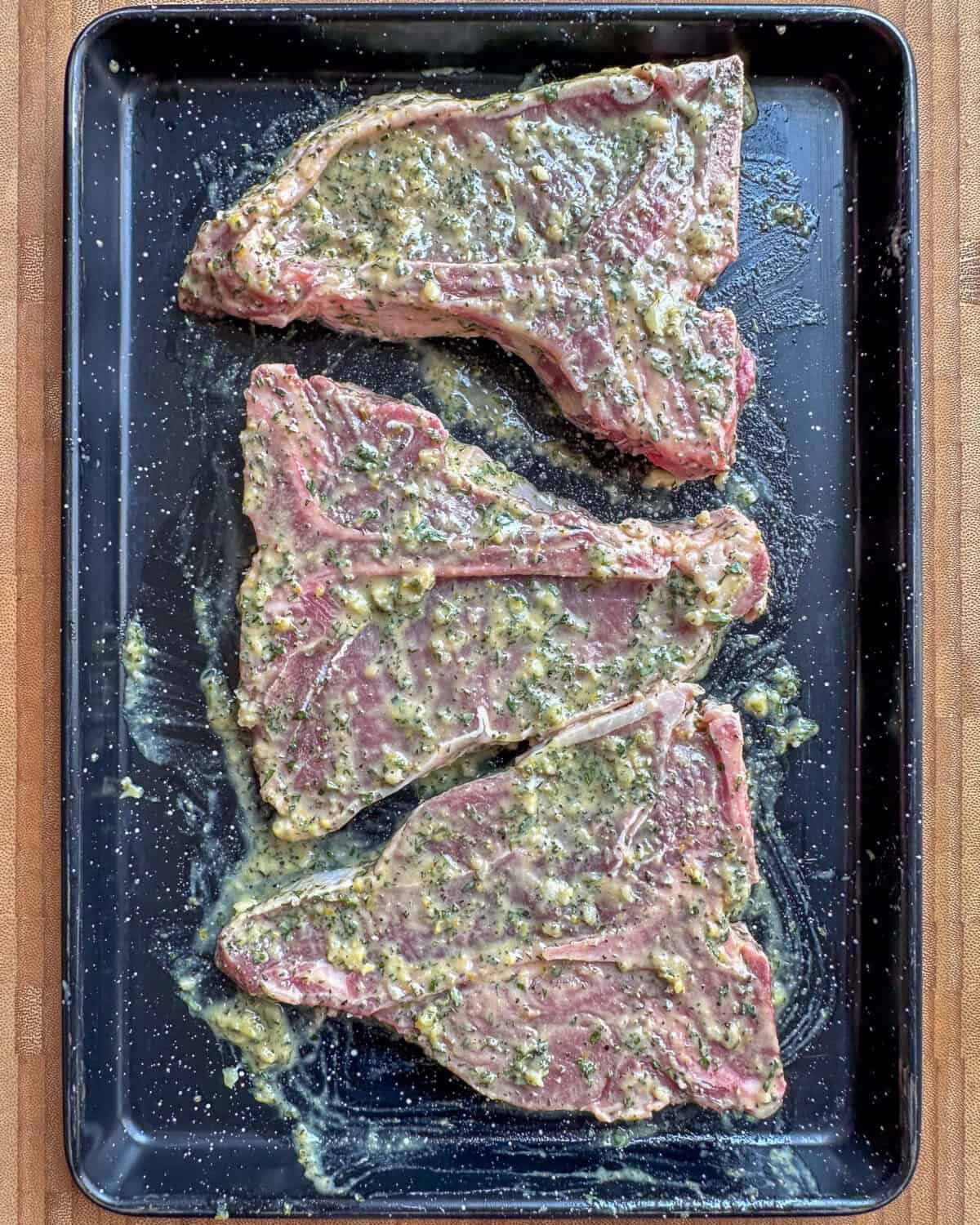 Veal chops marinated and ready to get grilled.