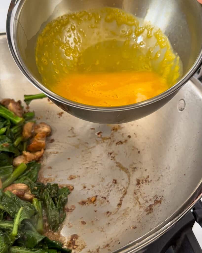 Push the chicken aside and make space in the wok to scramble eggs.