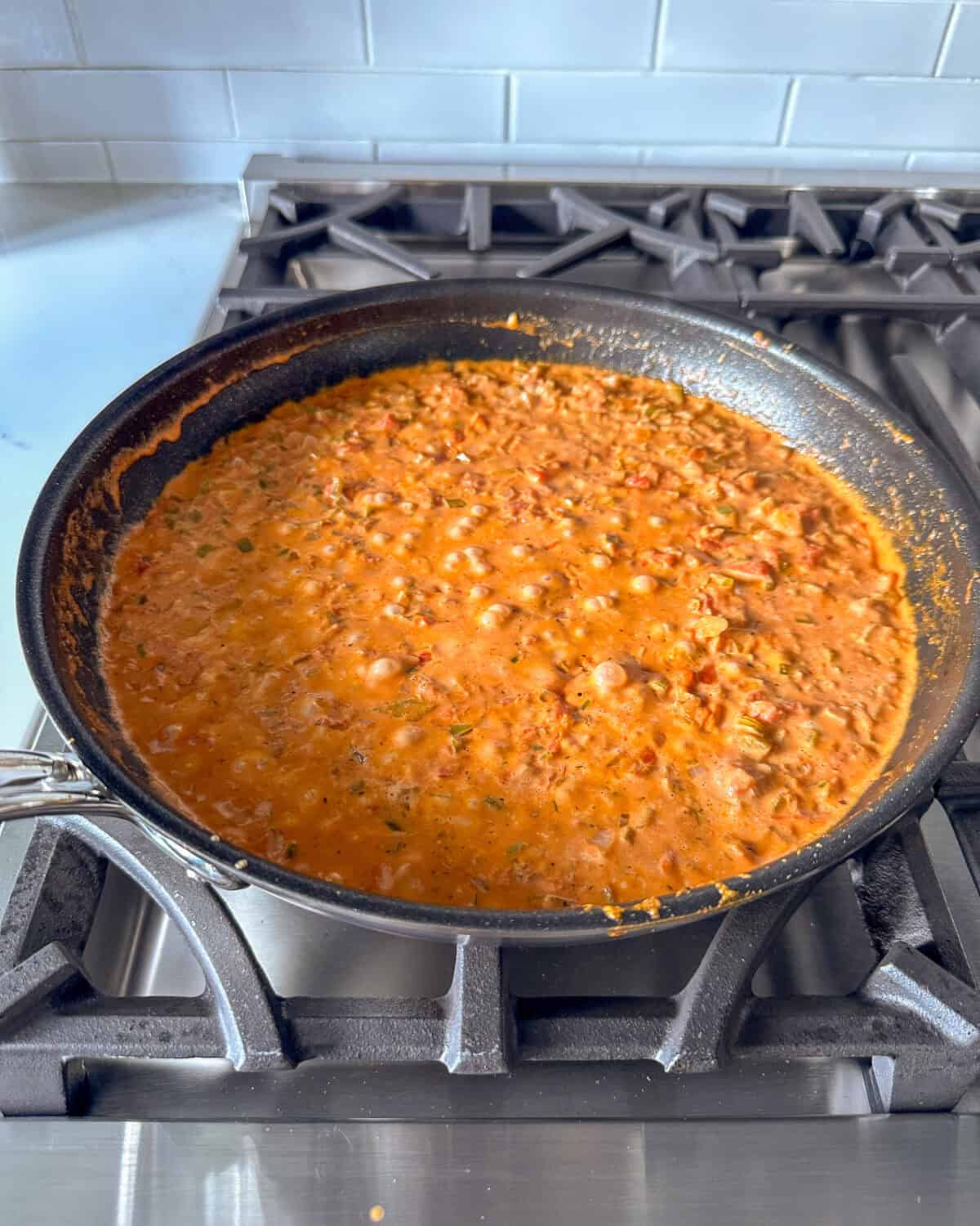 Simmering Creole sauce in a skillet.