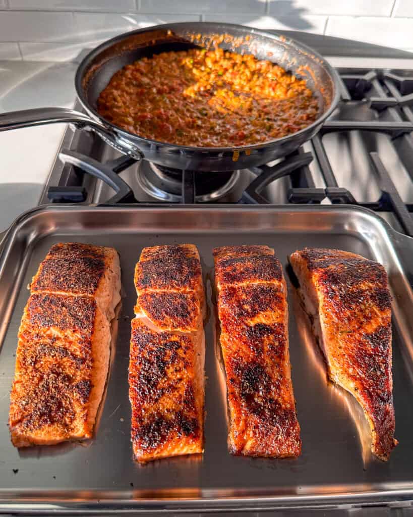 Four blackened salmon filets about to get finished off in the oven.