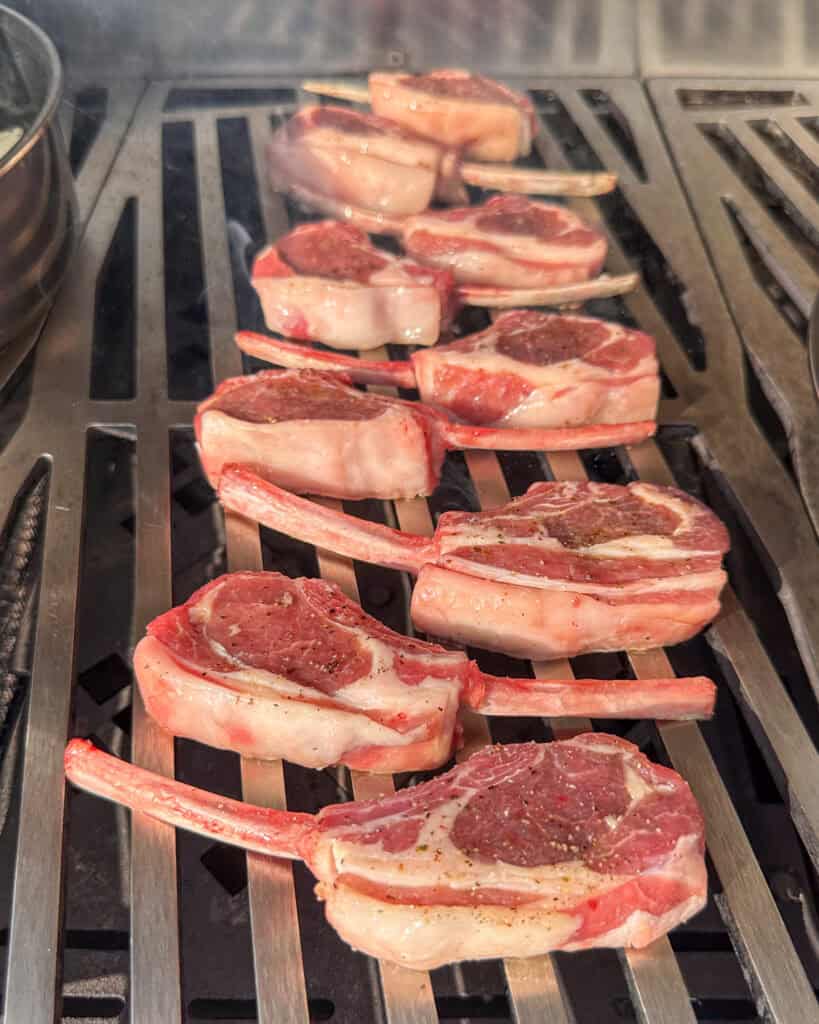 Nine frenched lamb chops on the grill.