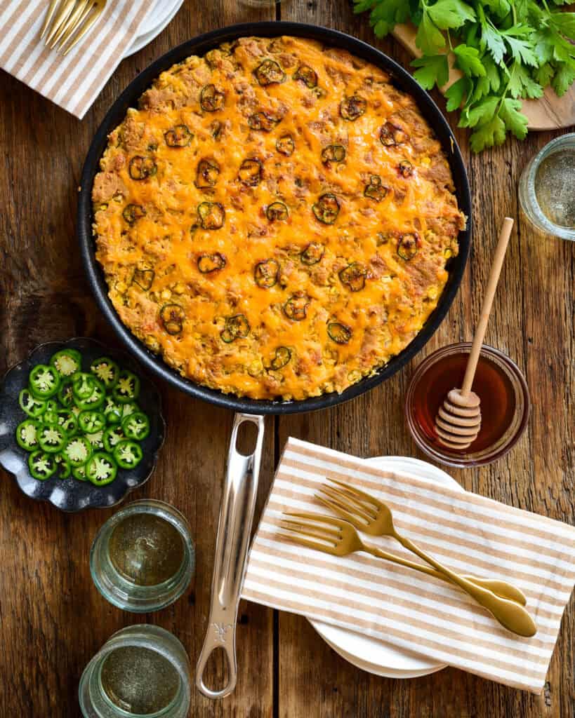 Skillet jalapeno cheddar cornbread with hot honey.