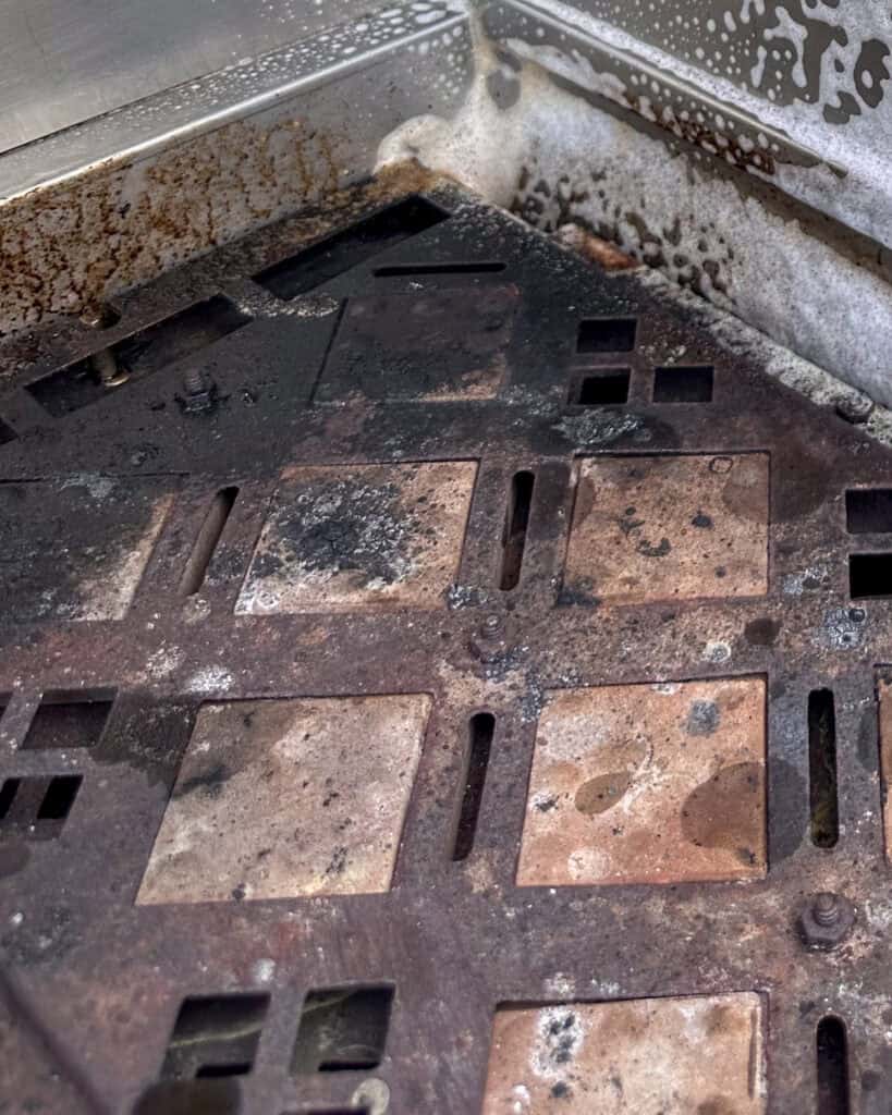 Dirty ceramic briquette trays in Hestan Grill.