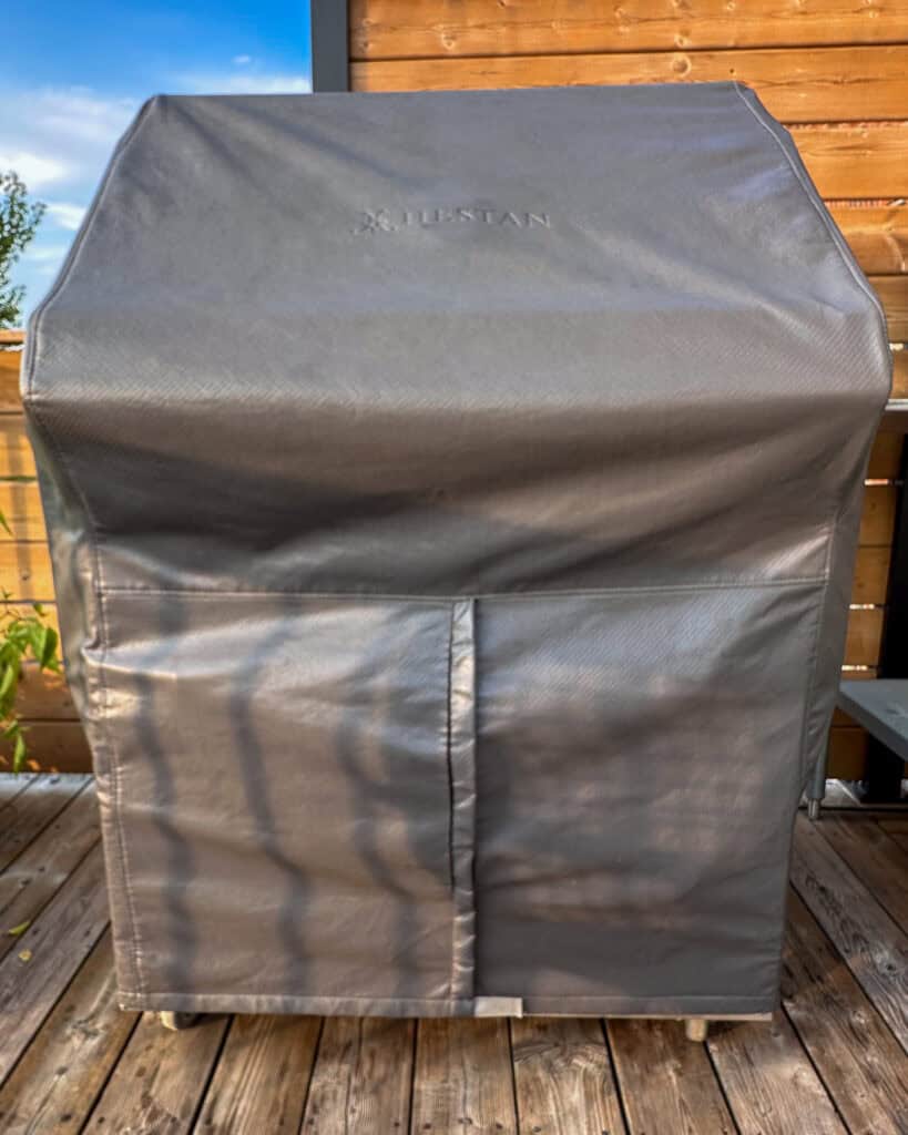 Hestan grill with grill cover on.