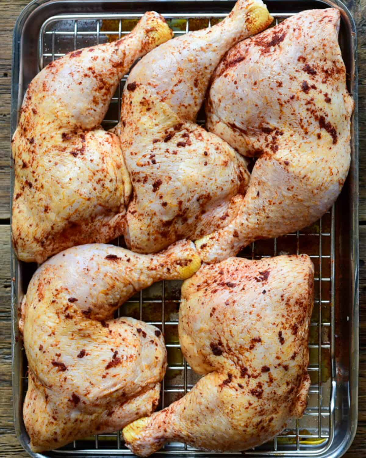 Five chicken legs seasoned with salt, pepper, and paprika.