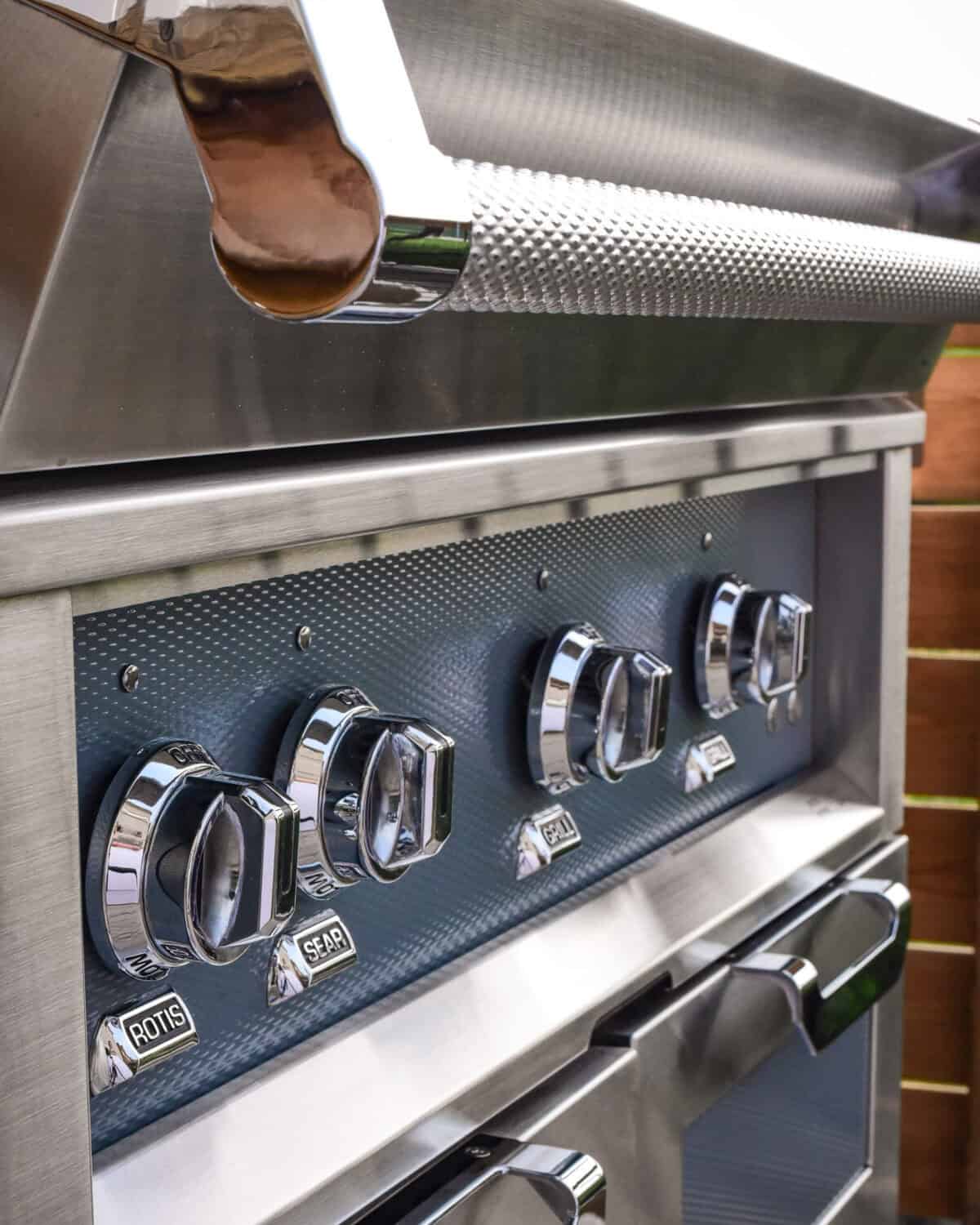 A polished Hestan grill with Commercial-grade handles and Marquise Accented panels.