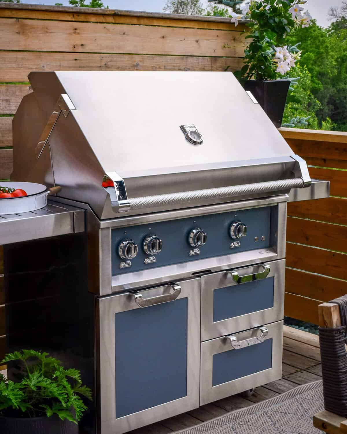 A clean Hestan gas grill with the hood closed.