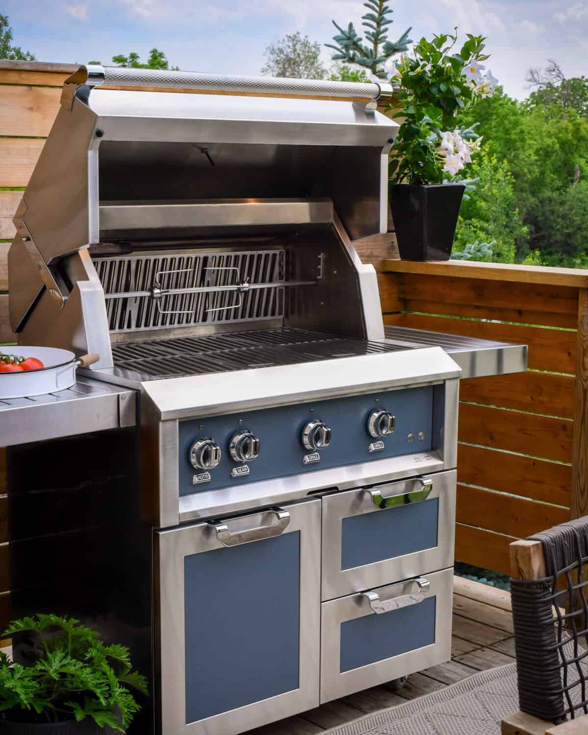 A clean Hestan gas grill with the lid open.