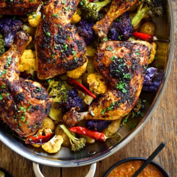 Baked Piri-Piri Chicken Legs on a bed of colourful cauliflour and potatoes.