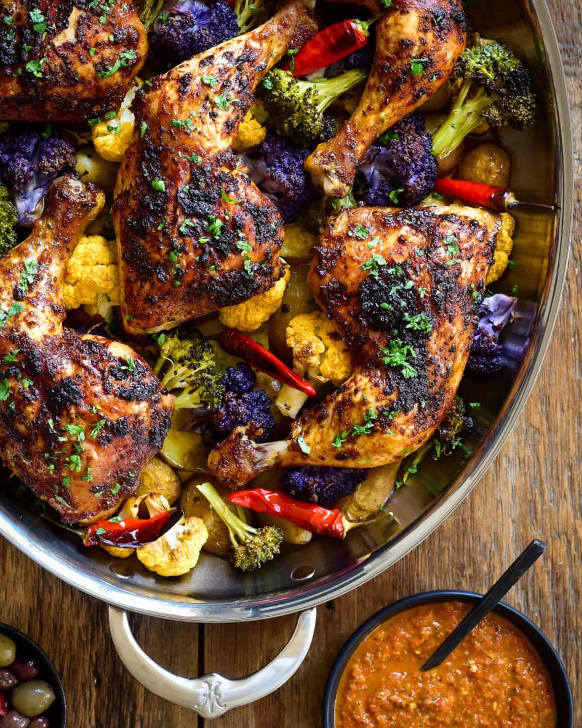 Roasted Piri-Piri Chicken Legs on a bed of colourful cauliflour and potatoes.