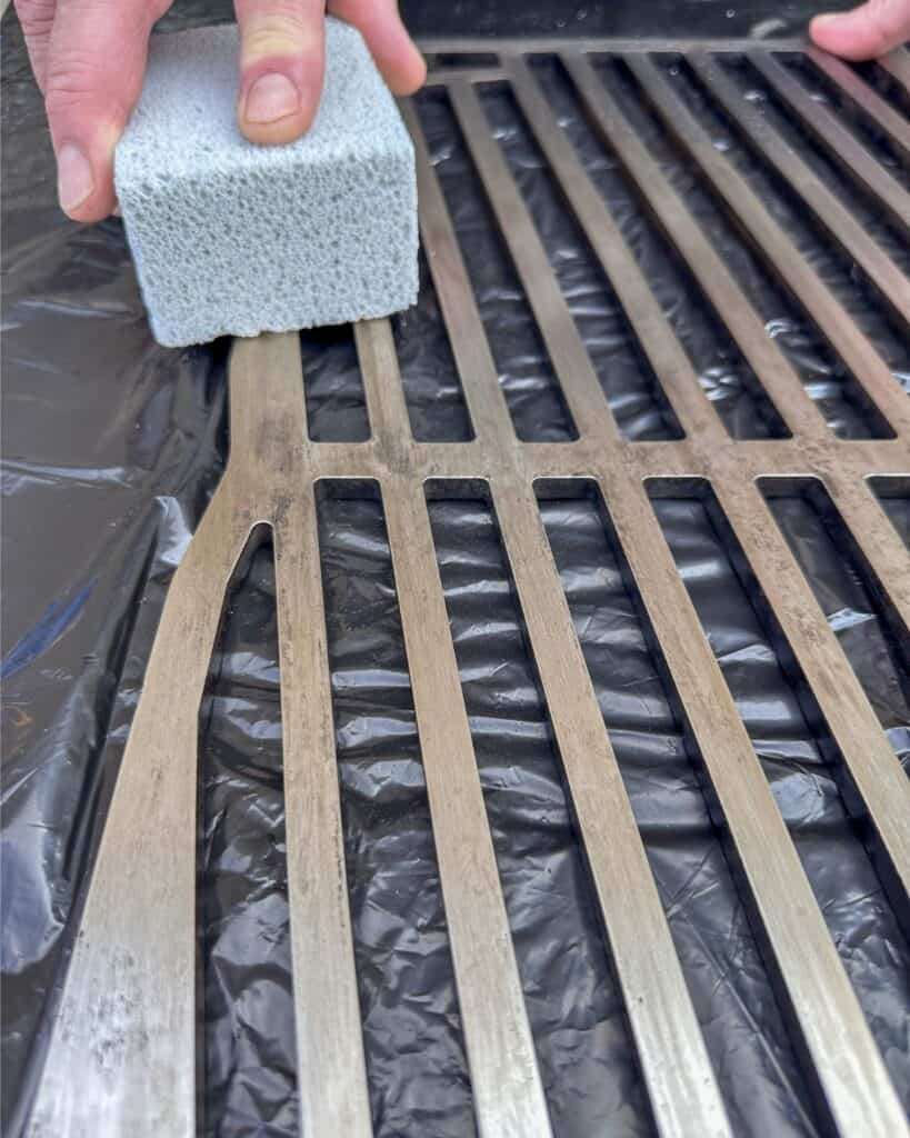 How to clean your gas grill grates with a scrubbing grill brick.