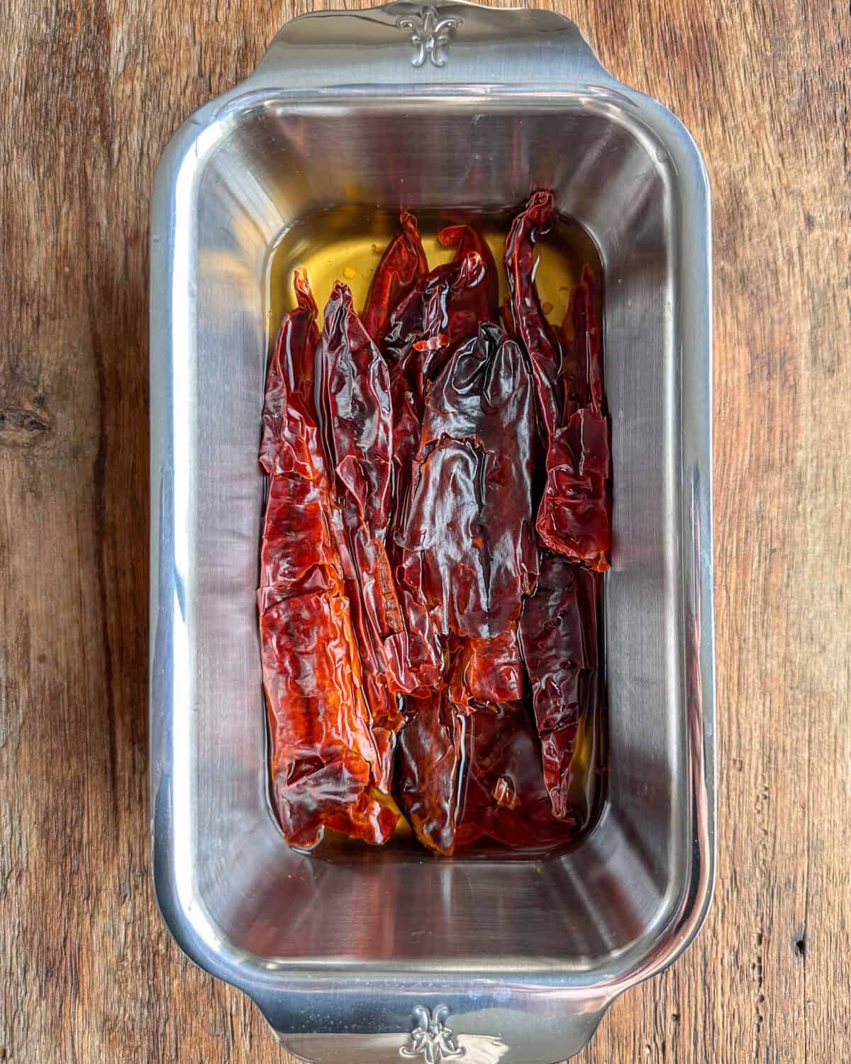 Place the guajillo peppers in a small pot or loaf pan. Pour boiling water over the peppers until just barely covered. Do not overfill, as the water will become part of the sauce. Let the peppers soak for about 20 minutes or until softened.