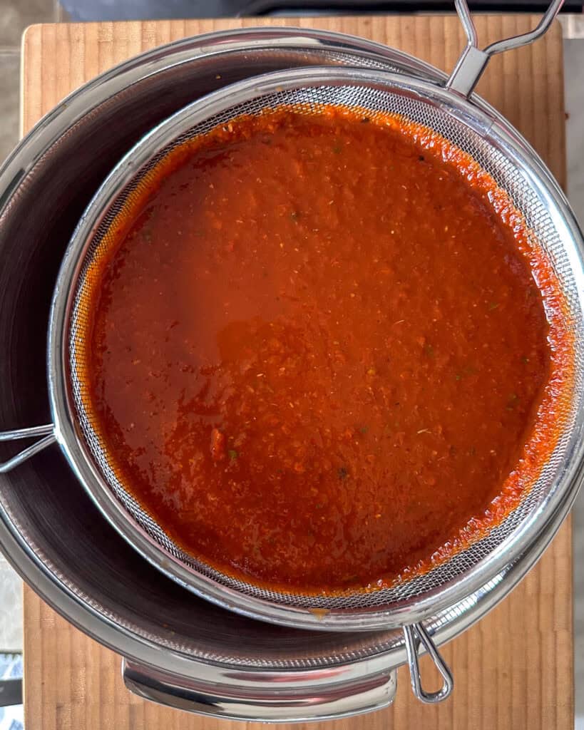 Strain the adobe sauce through a fine mesh sieve to remove any solids, resulting in a silky-smooth sauce.