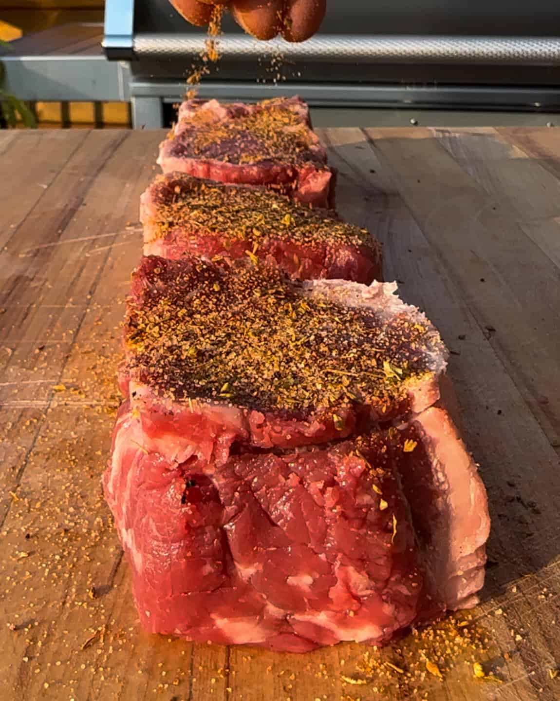 Steak medallions rubbed with seasoning.