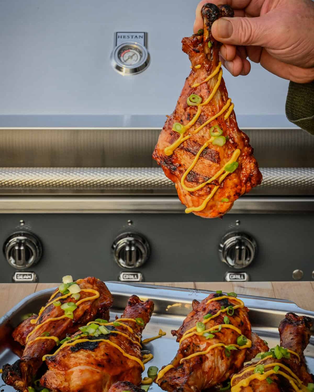 A turkey dumstick drizzled with the habanero aioli and sprinkle with chopped green onions.
