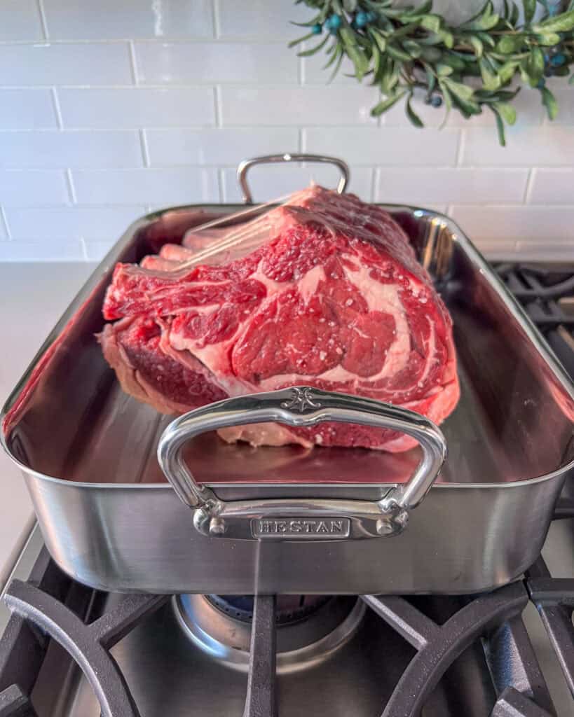 Place the roast fat side down in the roaster and sear.