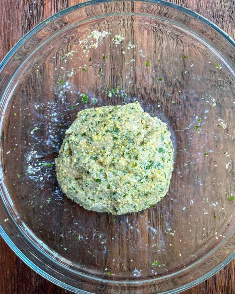 Gently mix in the ground turkey into the herb mixture into a ball.