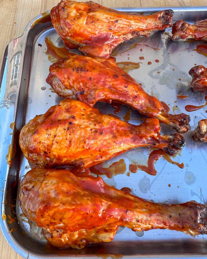 Brush the drumsticks with BBQ sauce.