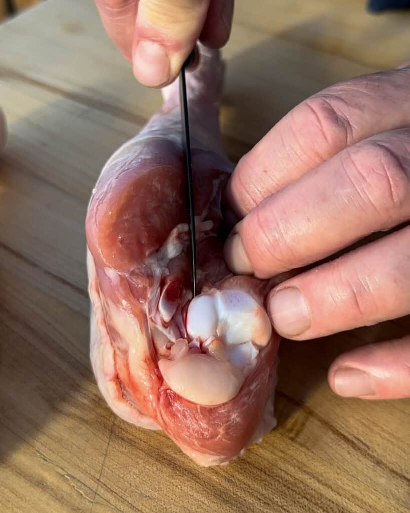How to butterfly turkey legs - Using a sharp knife, carefully slice down one side of the bone.