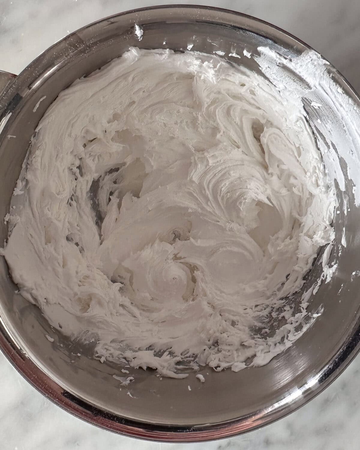 A bowl of whipped royal icing.