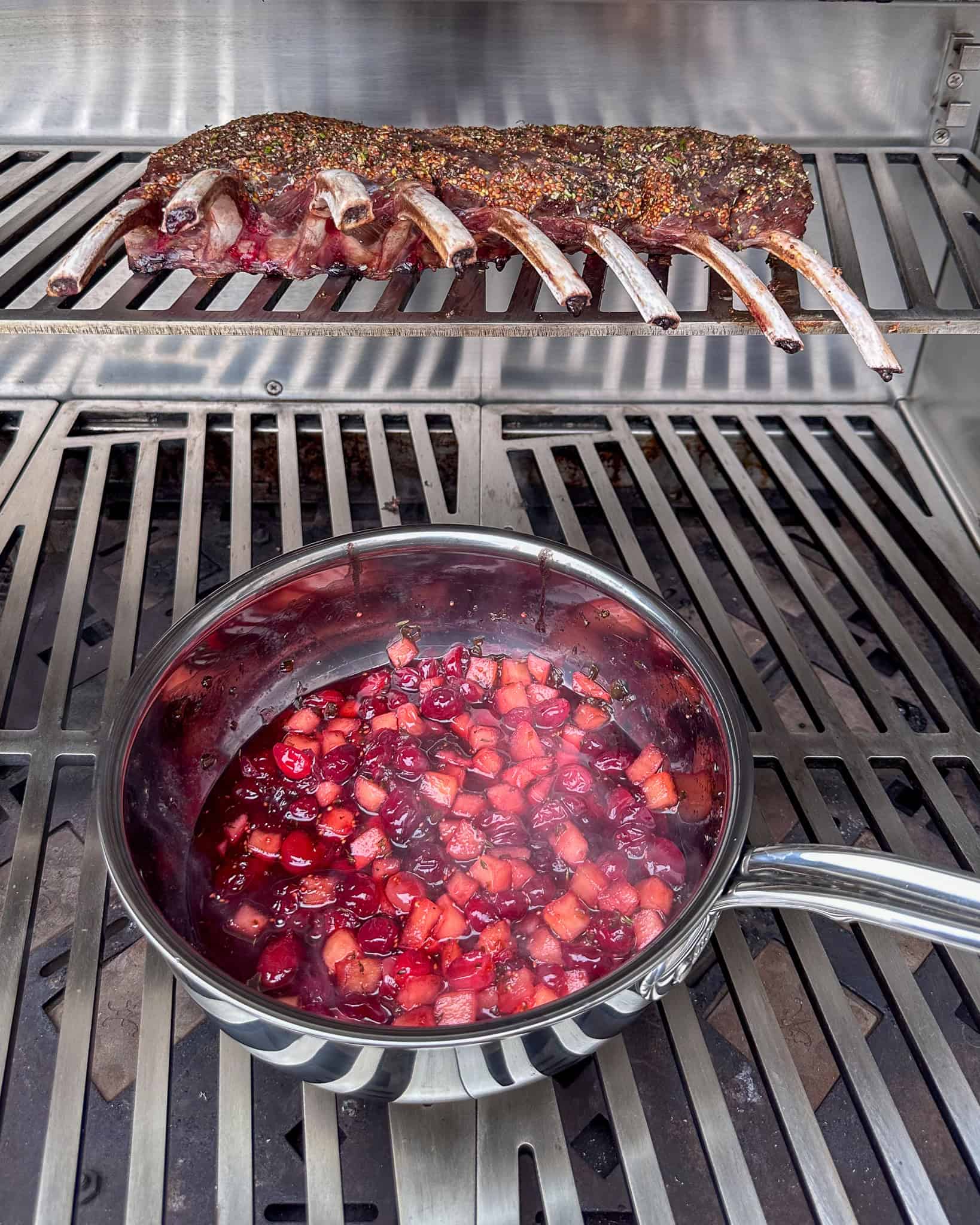 Place the venison rack on the upper rack of the grill, bone-side down.