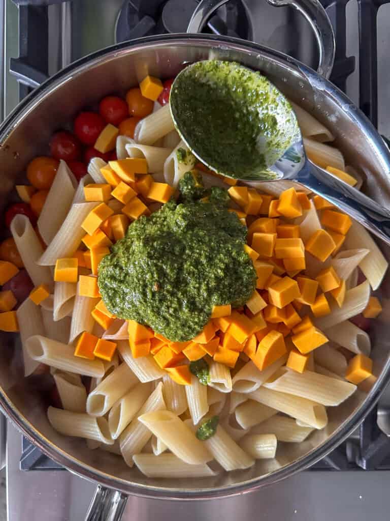 Tomatoes, pasta, squash and pesto added to to the pan.