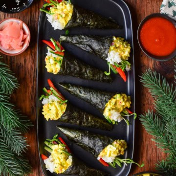 Seven Egg Salad Temaki Rolls on a platter in a festive setting.
