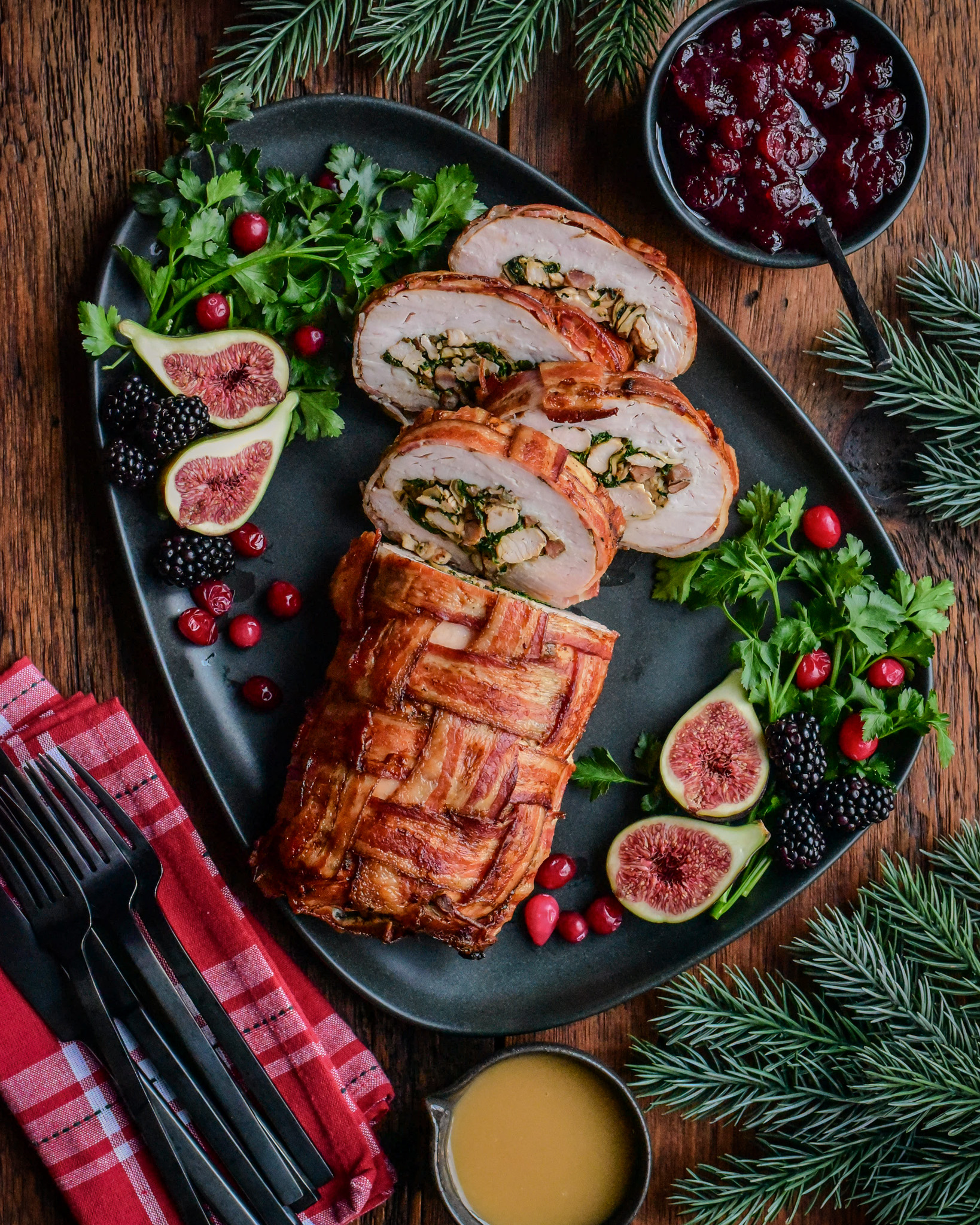 Bacon-Wrapped Stuffed Turkey Breast Served with mashed potatoes, gravy and cranberry sauce.