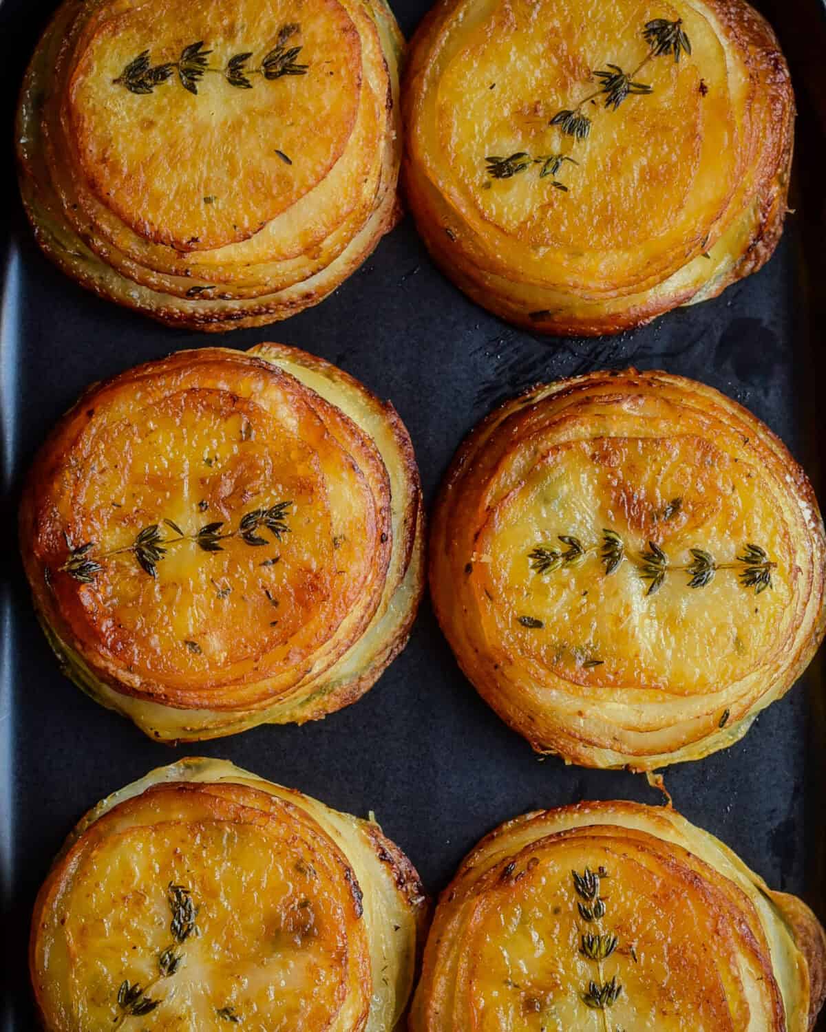 Crispy Piri-Piri Potato Stacks with a thyme sprig.