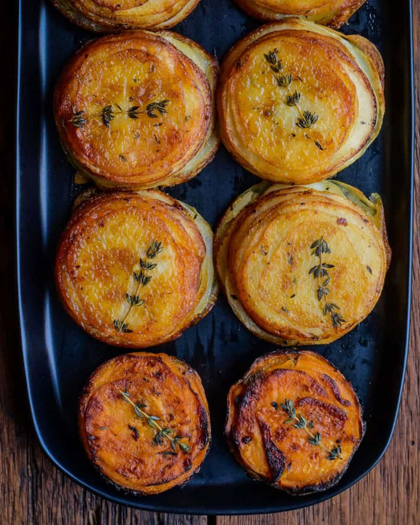 A close up of six potato stacks using russet and sweet potatoes.