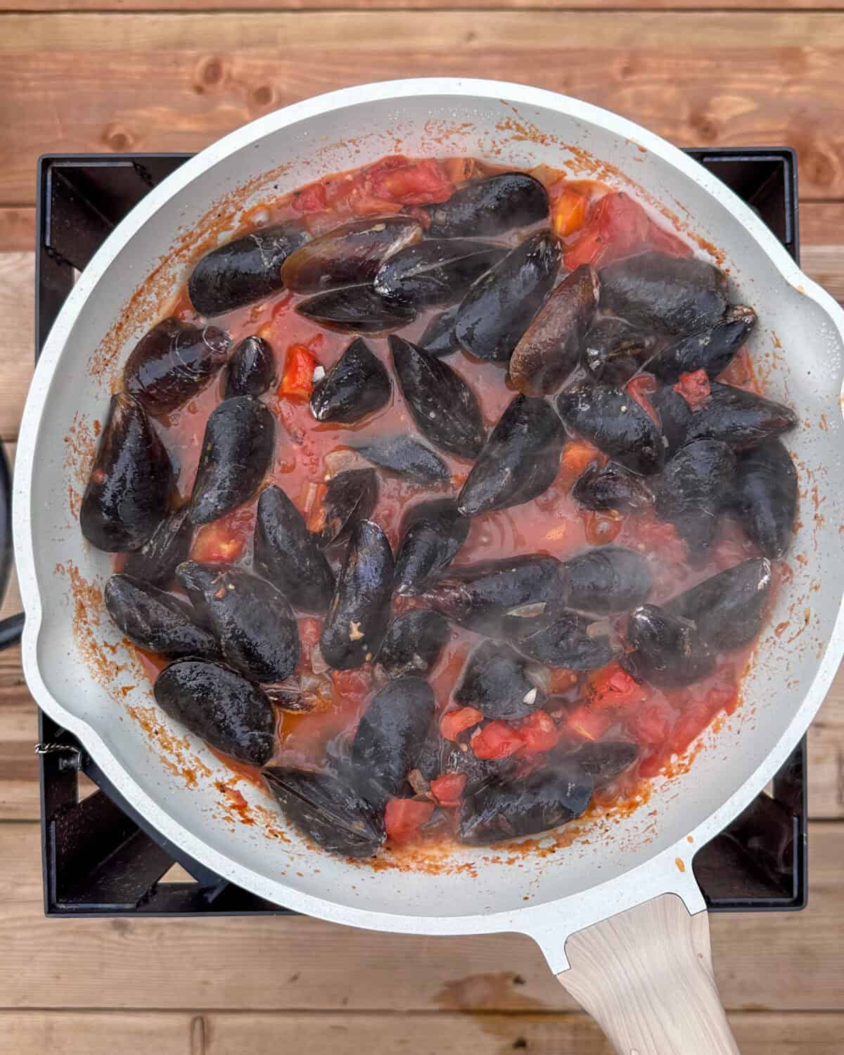 Add the PEI mussels to the broth.