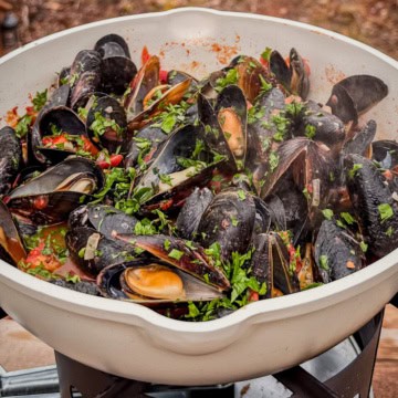 PEI Steamed mussels in white wine and tomato sauce with a squeeze fresh lemon juice & sprinkle with chopped parsley.